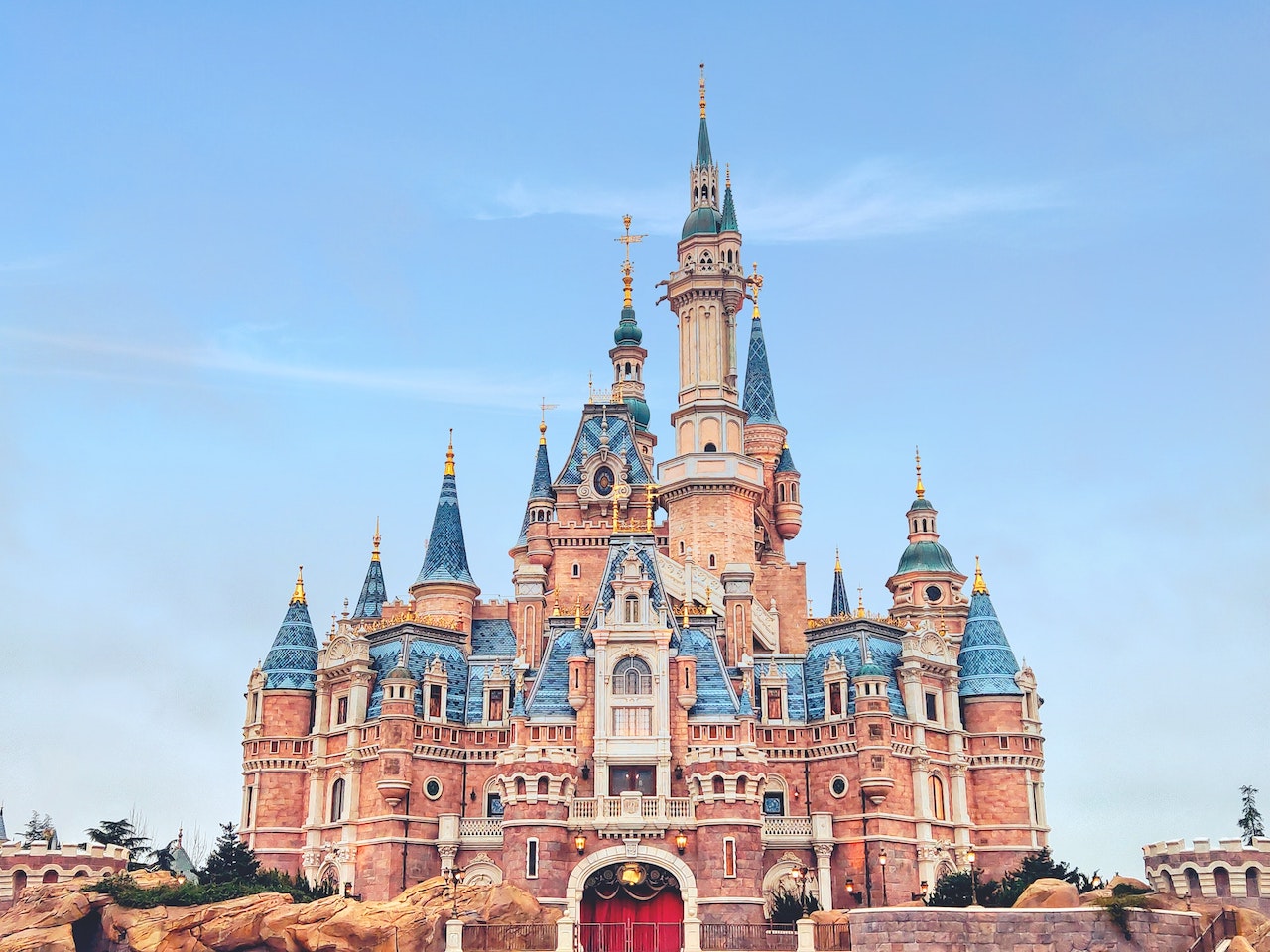 Walt Disney and Mickey statues in front of Cinderella's castle in Disneyland